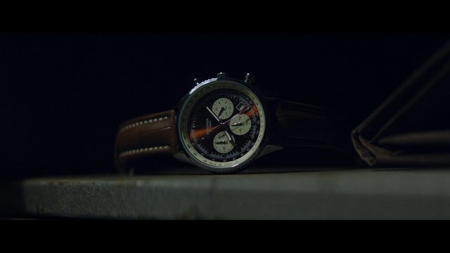 Video Reference: wristwatch, watch, close-up, leather strap, timepiece, dark background, product shot, macro, luxury, accessory, analog, chronograph, still life