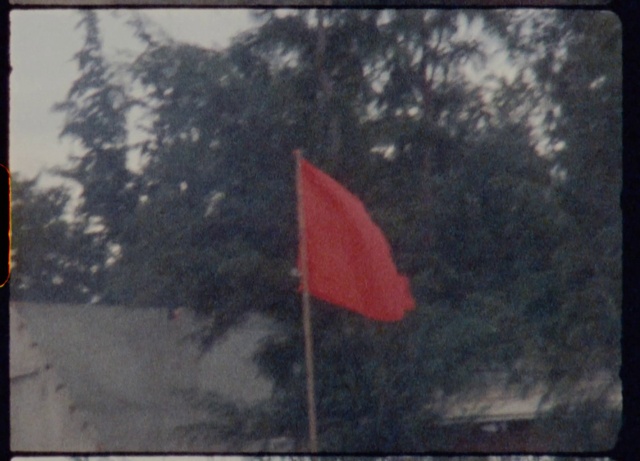 Video Reference: Flag, Sky, Rectangle, Tree, Tints and shades, Cumulus, Fixture, Event, Red flag, Pole