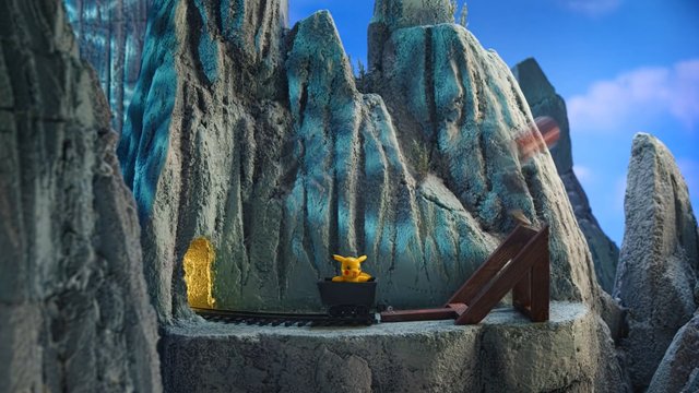 Video Reference: cartoon, animation, mine cart, rocky mountain, cliff, outdoor, adventure, yellow character, toy-like, fantasy, blue sky, track, terrain, playful, 3D