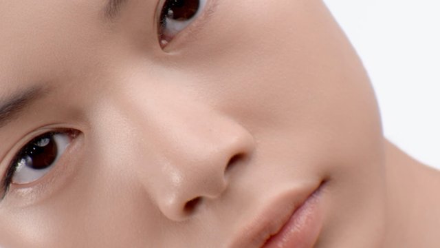 Video Reference: child, face, close-up, portrait, eyes, nose, lips, skin, diagonal, background, studio, neutral, blank, macro, human, toddler