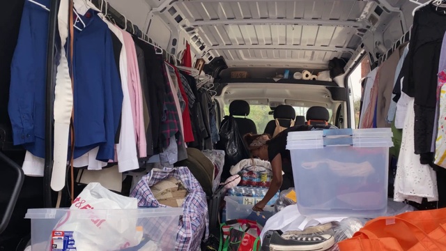 Video Reference: Motor vehicle, Selling, Automotive design, Hat, Clothes hanger, Vehicle, T-shirt, Market, Bag, City