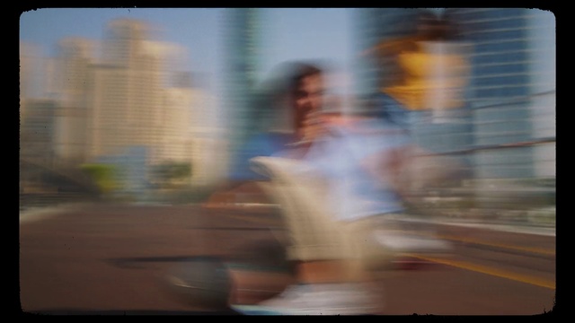 Video Reference: Sky, Tints and shades, Display device, City, Font, Sitting, Tower block, Reflection, Fun, Glass