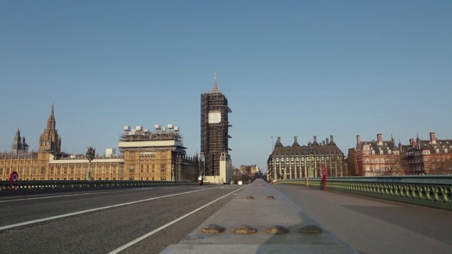 Video Reference: Sky, Building, Clock, Road surface, Morning, City, Thoroughfare, Asphalt, Facade, Road