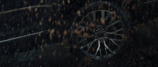 Video Reference: rain, vehicle, wheel, tire, close-up, motion blur, dark, wet, night, transportation, metal, storm