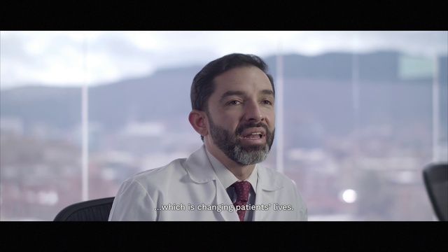 Video Reference: Forehead, Head, Beard, Mouth, Dress shirt, Flash photography, Jaw, Happy, Facial hair, Spokesperson