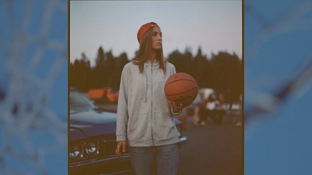 Video Reference: person, basketball, hoodie, cap, outdoor, car, standing, sports, blurred background, evening, casual, portrait