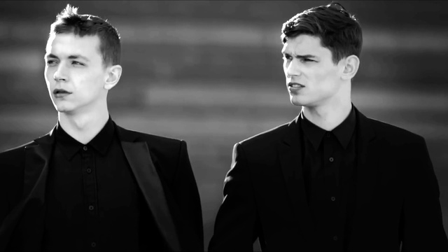 Video Reference: Forehead, Coat, Neck, Flash photography, Sleeve, Gesture, Style, Collar, Black-and-white, Dress shirt