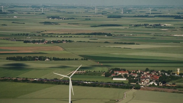 Video Reference: Windmill, Sky, Natural environment, Natural landscape, Highland, Land lot, Atmospheric phenomenon, Slope, Grassland, Grass