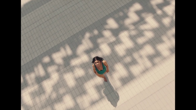 Video Reference: Grey, Rectangle, Font, Wall, Tints and shades, Pattern, Flooring, Asphalt, Symmetry, Road surface