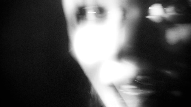 Video Reference: Nose, Lip, Eyelash, Mouth, Human body, Flash photography, Jaw, Neck, Gesture, Black-and-white