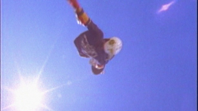 Video Reference: Sky, Atmosphere, Sports equipment, Gesture, Slope, Snowboard, Tree, Lens flare, Electric blue, Recreation