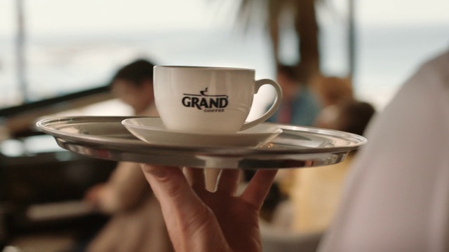 Video Reference: Tableware, Drinkware, Dishware, Coffee cup, Hat, Cup, Serveware, Eyewear, Gesture, Saucer
