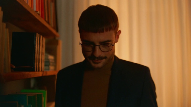 Video Reference: Forehead, Glasses, Chin, Vision care, Bookcase, Eyewear, Shelf, Blazer, Publication, Suit