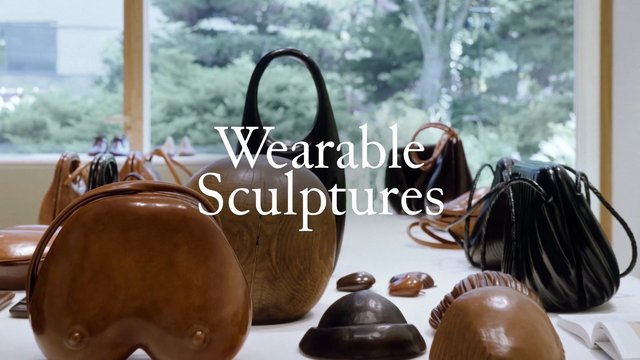 Video Reference: handbags, bags, fashion, luxury, design, art, sculpture, display, interior, window, garden, product showcase, accessories, modern, branding, text overlay