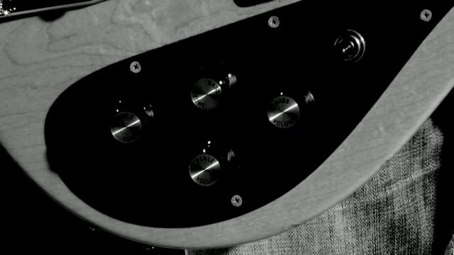 Video Reference: electric guitar, guitar body, close-up, black and white, instrument, music, control knobs, pickup selector, hardware, string instrument, detail shot