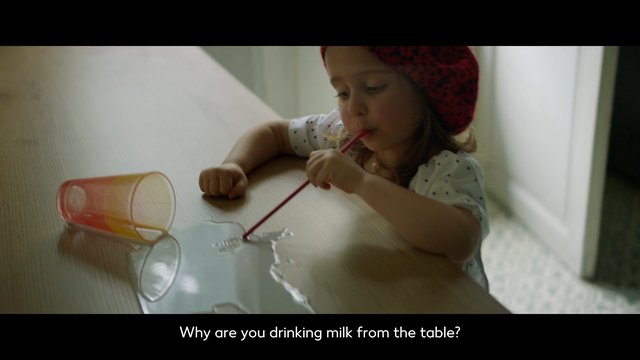 Video Reference: child, table, spilled milk, straw, cup, indoor, drink, mess, playful, toddler, home, close-up