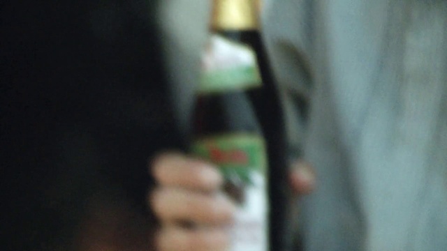 Video Reference: Sleeve, Gesture, Tints and shades, Nail, Wrist, Elbow, Electric blue, Darkness, Human leg, Glass bottle