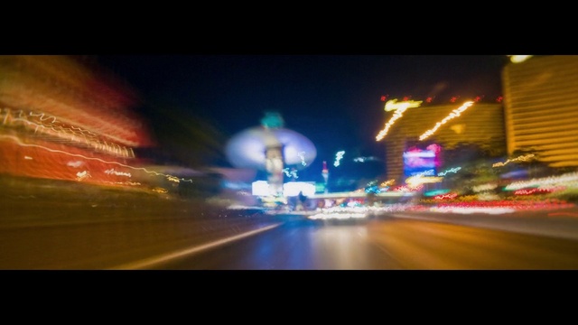 Video Reference: Automotive lighting, Building, Asphalt, Car, Orange, Mode of transport, Thoroughfare, Font, Electricity, Rectangle