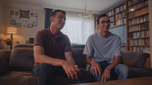 Video Reference: Muscle, Bookcase, Comfort, Shelf, Table, Eyewear, Couch, Wood, T-shirt, Smile