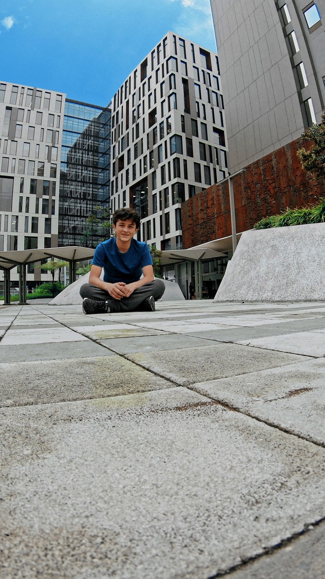 Video Reference: Building, Road surface, Asphalt, Plant, Grey, Street fashion, Sidewalk, Wall, Public space, Urban design