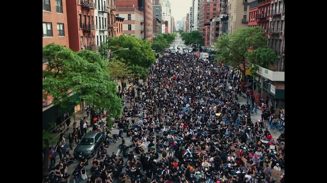 Video Reference: Building, Plant, Tree, Urban design, Wall, Neighbourhood, Thoroughfare, City, Metropolitan area, Crowd