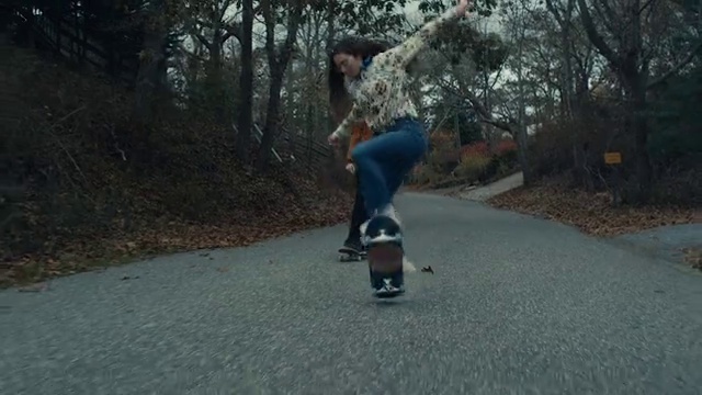 Video Reference: Footwear, Skateboard deck, Sports equipment, Asphalt, Tree, Outdoor recreation, Rolling, Skateboarder, Plant, Skateboard truck