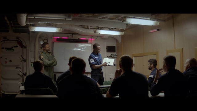 Video Reference: Outerwear, Coat, T-shirt, Event, Suit, Public speaking, Whiteboard, Presentation, Job, Chair