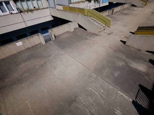 Video Reference: concrete, courtyard, rooftop, ramp, stairs, railings, urban, architecture, empty, outdoor, walkway, building, geometry, pavement