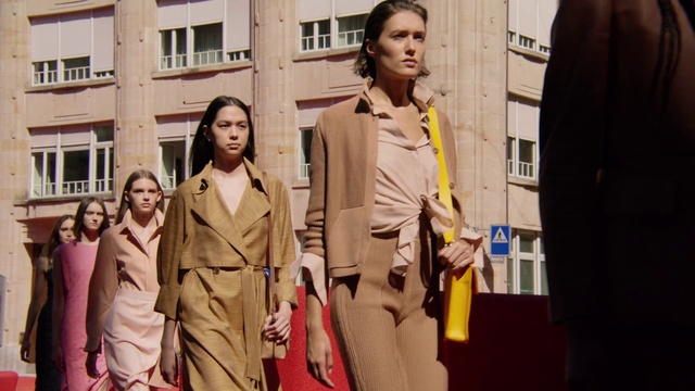 Video Reference: Window, Street fashion, Sleeve, Orange, Standing, Waist, Fashion design, Blazer, Formal wear, Event