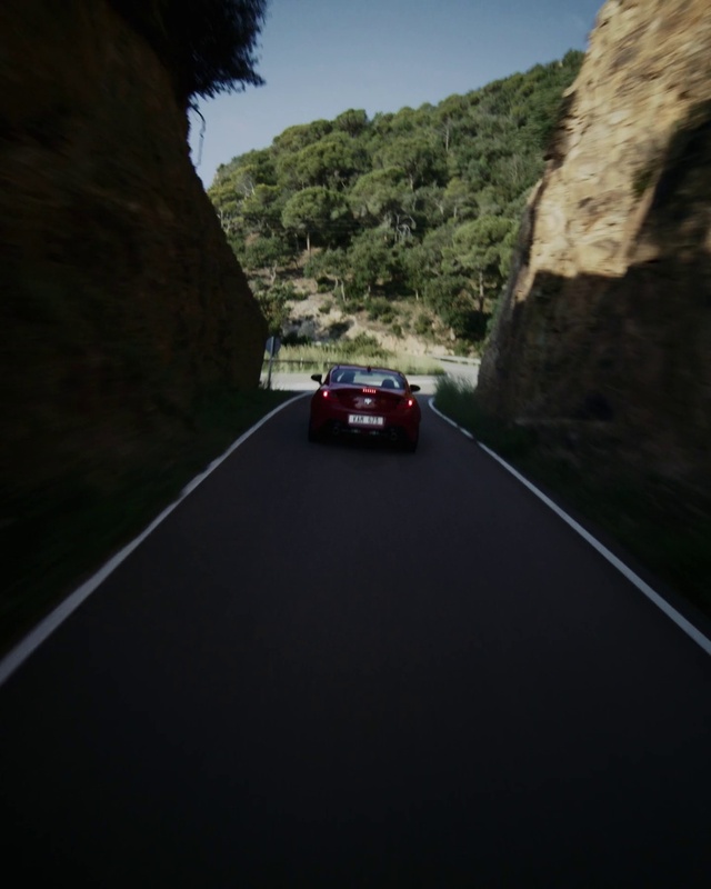 Video Reference: Car, Vehicle, Sky, Mountain, Road surface, Asphalt, Automotive lighting, Motor vehicle, Automotive design, Tree