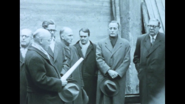 Video Reference: Coat, Gesture, Collar, Blazer, Suit, Crew, Formal wear, Event, Vintage clothing, White-collar worker