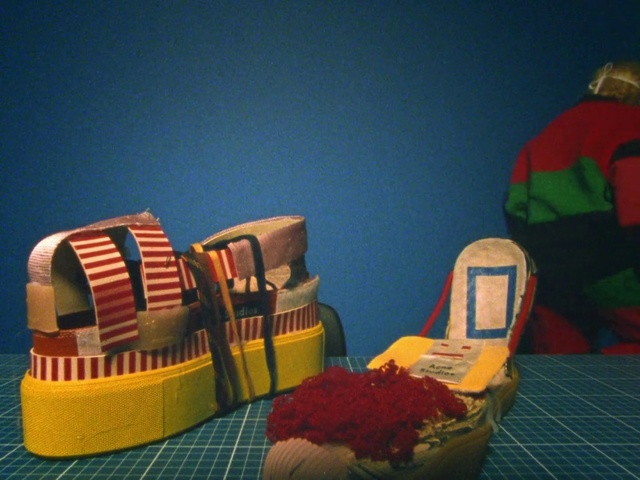 Video Reference: Product, Toy, Lego, Room, Electric blue, Personal protective equipment, Font, Automotive wheel system, Automotive tire, Animation