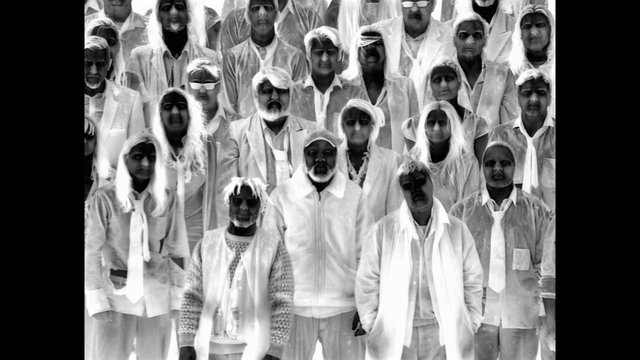 Video Reference: group portrait, people, black and white, standing, crowd, faces, formal pose, light clothing, symmetry, portrait