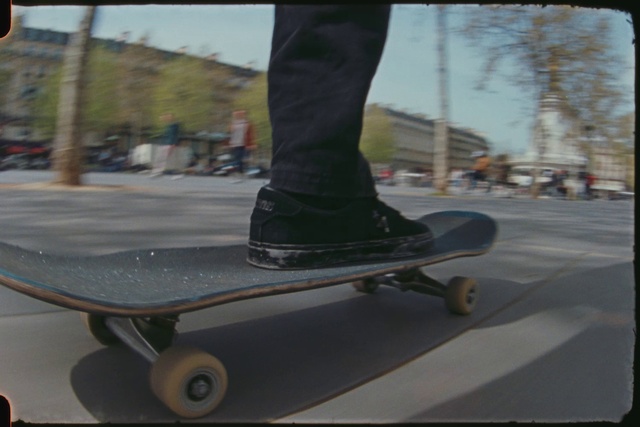 Video Reference: Wheel, Sky, Sports equipment, Asphalt, Skateboard, Vehicle, Skateboarder, Rolling, Tree, Kickflip