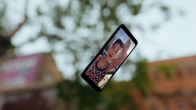 Video Reference: Mobile phone, Plant, Communication Device, Gadget, Tree, Font, Art, Signage, Road, Smartphone