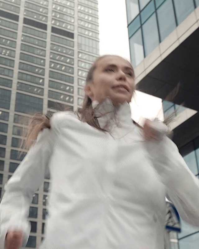 Video Reference: Window, Building, Dress shirt, Sleeve, Gesture, White coat, Blazer, White-collar worker, Formal wear, Fashion design