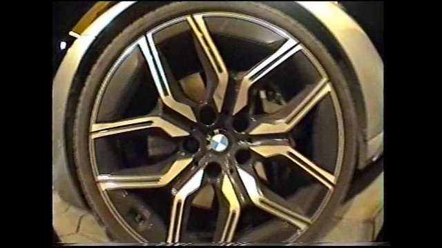 Video Reference: car wheel, alloy rim, wheel close-up, tire, automotive, rim, metallic, gold, black, spokes, center cap, vehicle part