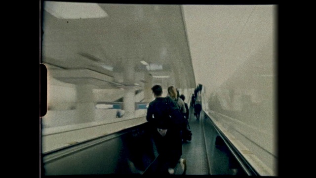 Video Reference: Rectangle, Tints and shades, Symmetry, Road, Glass, City, Visual arts, Public transport, Monochrome photography, Suit