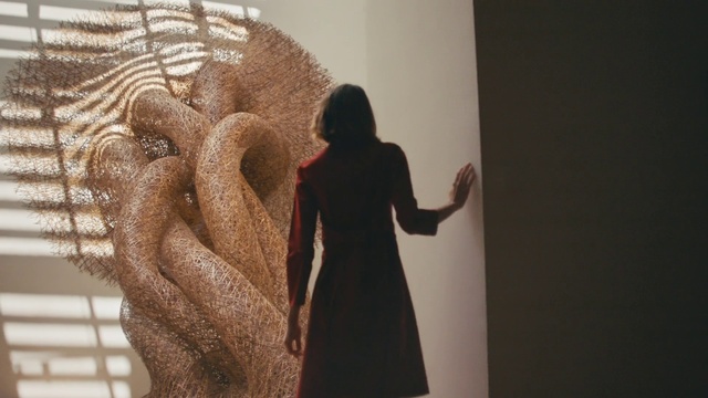 Video Reference: Art, Sculpture, Gesture, Wood, Event, Tree, Fashion design, Font, Visual arts, Shadow