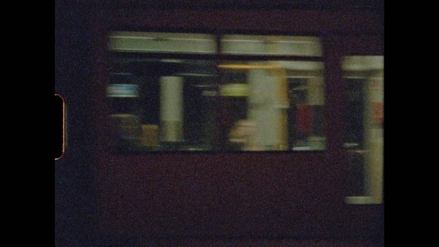 Video Reference: blurry, low light, indoor, station, platform, window view, motion blur, dark, transit, night, grainy, interior, commute