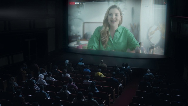 Video Reference: Smile, Chair, Movie theater, Projection screen, Projector accessory, Entertainment, Event, Display device, Public speaking, Multimedia