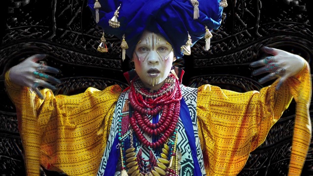 Video Reference: Outerwear, Blue, Black, Temple, Event, Street fashion, Fashion design, Tradition, Public event, Fashion accessory