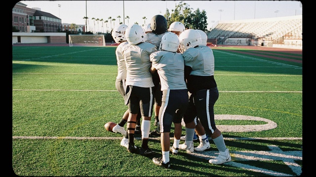 Video Reference: Footwear, Shorts, Sports equipment, Player, Gesture, Sports gear, Football equipment, Grass, Jersey, American football