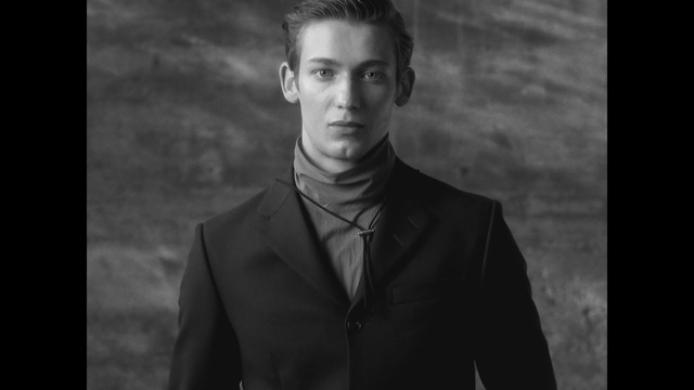 Video Reference: Forehead, Hair, Chin, Flash photography, Jaw, Sleeve, Pompadour, Black-and-white, Style, Eyelash