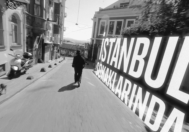 Video Reference: Building, Window, Road surface, Black-and-white, Style, Sky, Asphalt, Road, Sidewalk, City