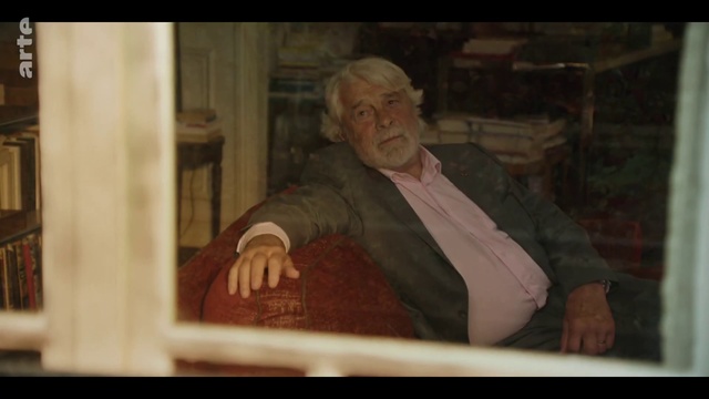 Video Reference: Gesture, Wood, Blazer, Suit, Wrinkle, Pleased, Vintage clothing, Sitting, Visual arts, Photo caption