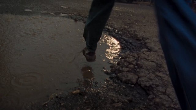 Video Reference: puddle, mud, road, walking, footstep, wet, rain, night, reflection, pavement, street, close-up, outdoors, damage, legs
