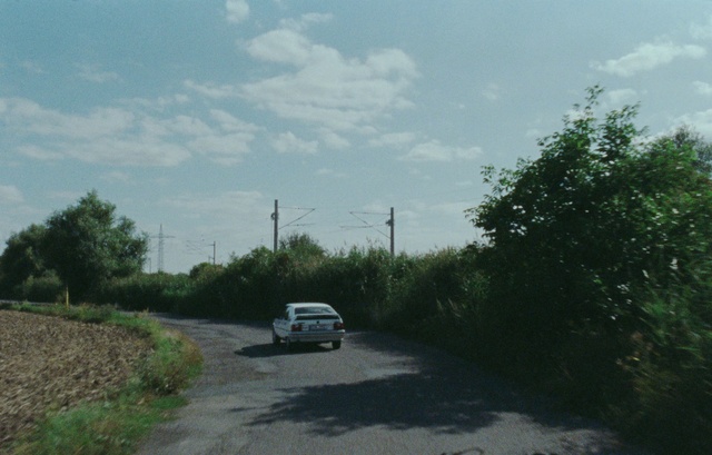 Video Reference: Cloud, Sky, Plant, Car, Vehicle, Motor vehicle, Road surface, Asphalt, Land lot, Tree