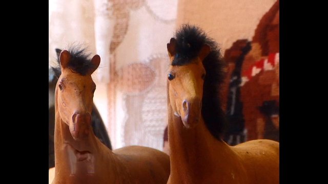 Video Reference: toy, horse, figurine, miniature, close-up, indoor, animal figure, decorative, pair, plastic, brown, black mane, still life