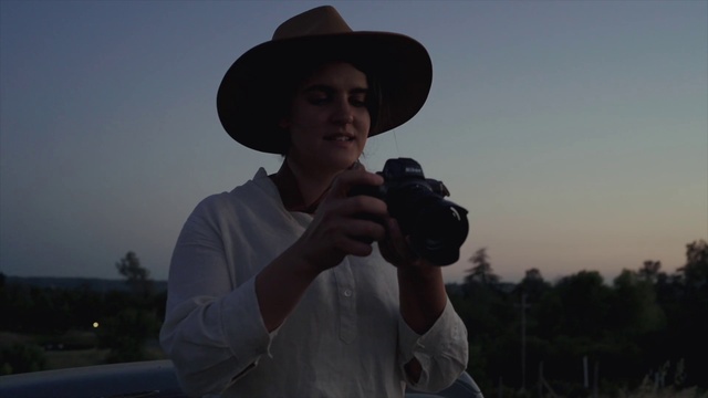 Video Reference: Sky, Hand, Arm, Photographer, Hat, Flash photography, Camera lens, Reflex camera, Fedora, Standing